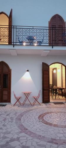 a building with a patio with a table on it at Le Tartane B&b Guidaloca in Castellammare del Golfo