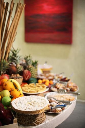 a table with a bunch of different types of food at Hotel Trieste in Rimini