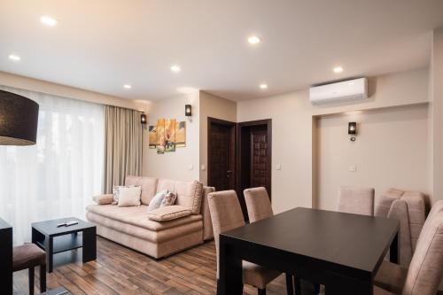 a living room with a couch and a table at Hotel Central Beach 9 in Makarska
