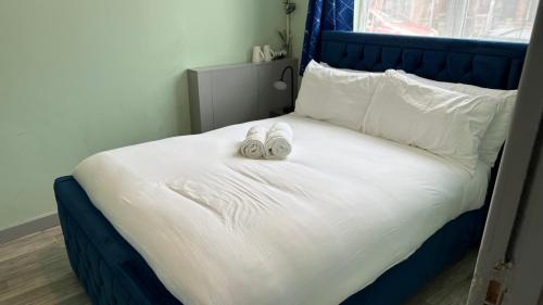 a bed with two slippers on top of it at Homestay in Walsall in Walsall