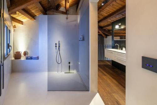 a bathroom with a shower in the middle of a room at casa vipp in Andorra la Vella