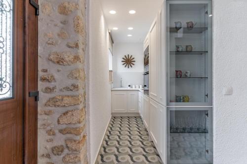 a hallway with a walk in pantry with a door at IKIA KATSANI in Afitos