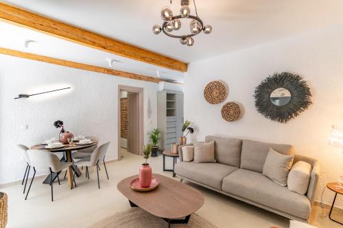 a living room with a couch and a table at IKIA KATSANI in Afitos
