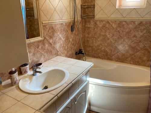 a bathroom with a sink and a bath tub at Pentz House in Siófok