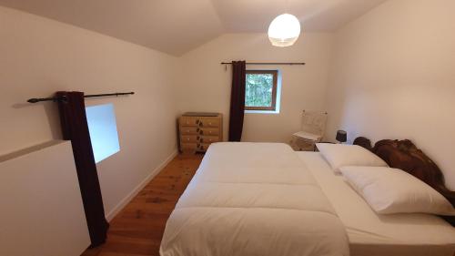 a bedroom with two beds and a window at La Louve in Basse-sur-le-Rupt