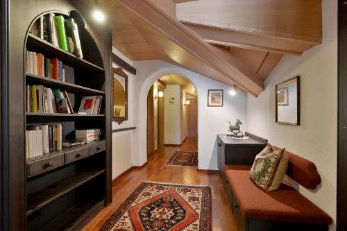 a hallway with a book shelf with books at Alpenhotel Kramerwirt in Mayrhofen