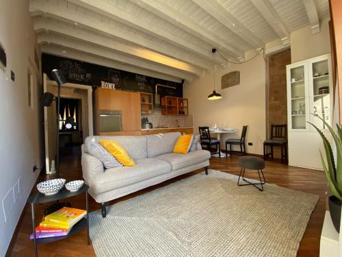 a living room with a couch and a table at A view on Brescia's rooftops in Brescia