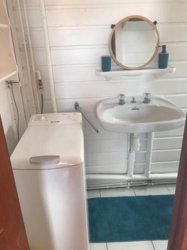 a bathroom with a sink and a toilet and a mirror at Tite halte in Saint-Claude