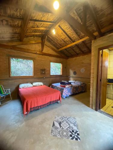 a large room with two beds in a cabin at CAFOFO DA GIO in Conceição da Ibitipoca