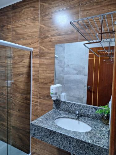a bathroom with a sink and a mirror at Hotel Reserva do Xingó in Piranhas