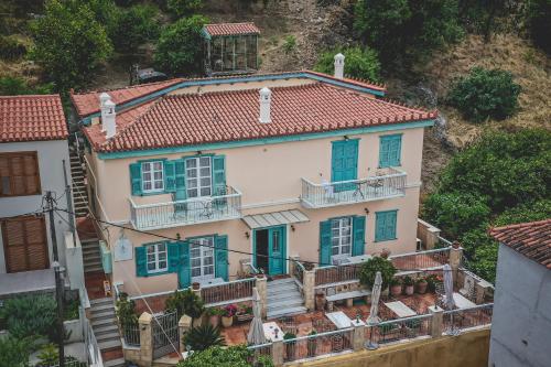 a large white house with blue windows and stairs at Acronafplia Pension A in Nafplio