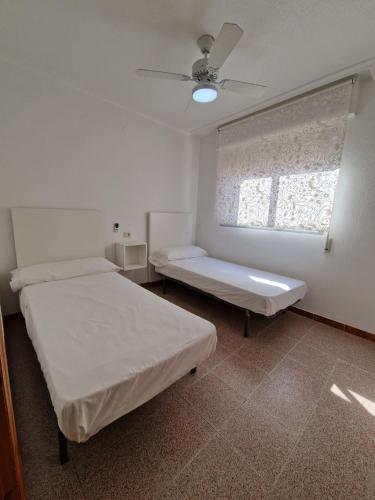 a hospital room with two beds and a window at Apartamento CA VALEN 1 in Peniscola