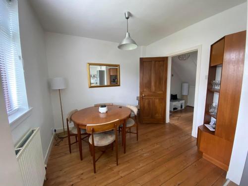a dining room with a table and a mirror at Sealladh Na Mara, Pittenweem in Pittenweem