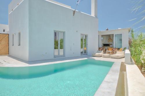 a swimming pool in the middle of a house at Villa Yialos in Antiparos