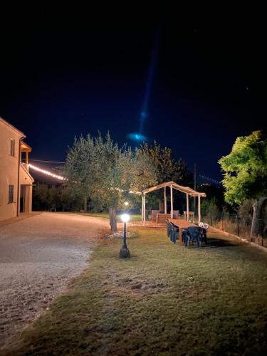 a park with a picnic table and a pavilion at night at L'Antica Colombaia; Apartment with private entrance in Ostra