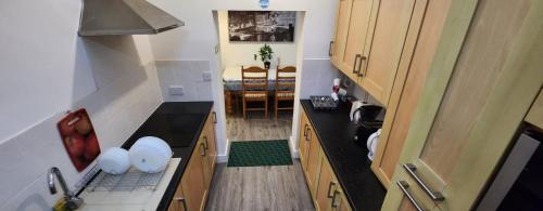 an overhead view of a kitchen with a sink and a dining room at White House Ensuite double bedroom in Warrington