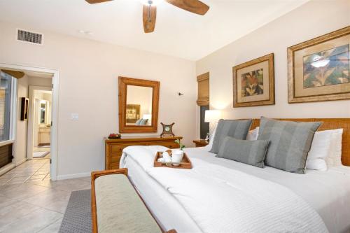 a bedroom with a large white bed and a mirror at K B M Resorts Kapalua Bay Villas KBV 17G4 bed Ocean Front in Kapalua