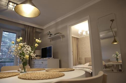 a room with two tables and a mirror and a bedroom at Apartament nad Zegrzem 206 Luksus in Serock