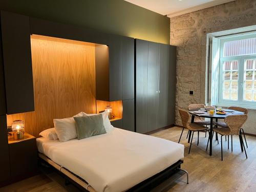 a hotel room with a bed and a table at Oca Ribeira do Porto AT in Porto