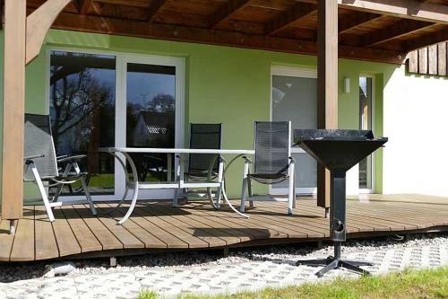 a deck with chairs and a grill on a house at Ruegen_Fewo 279_2 in Kasnevitz