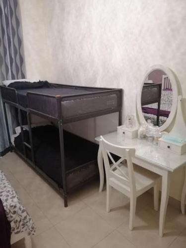 a black piano with a mirror and a table at Dead Sea Jordan Sea View Samarah Resort Traveler Award 2024 winner in Sowayma
