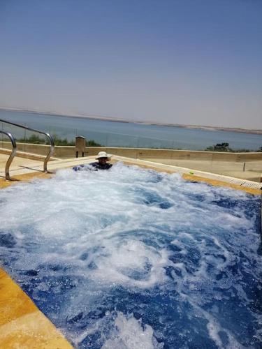 a jacuzzi tub filled with lots of blue water at Dead Sea Jordan Sea View Samarah Resort Traveler Award 2024 winner in Sowayma