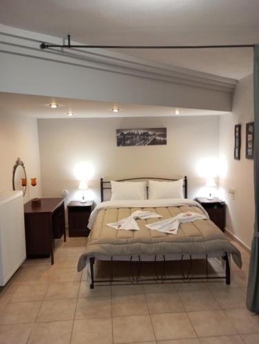 a bedroom with a bed and two night stands at City Nikis Apartment in Volos