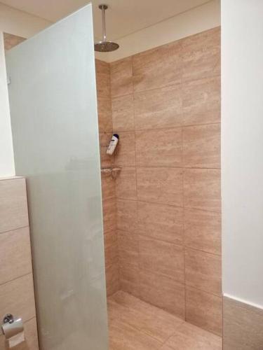 a shower with a glass door in a bathroom at Dead Sea Jordan Sea View Samarah Resort Traveler Award 2024 winner in Sowayma