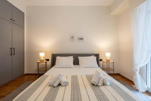 a bedroom with a large bed with two pillows on it at Urban Casa in Athens
