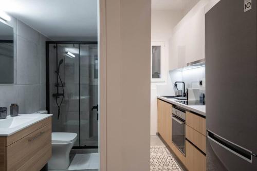 a bathroom with a shower and a toilet and a sink at Urban Casa in Athens