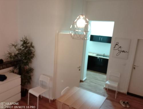 a room with a white refrigerator and a window at Logement Régence in Liège