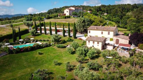 an aerial view of an estate with a pool and a house at Podere "la svolta" in Chianni