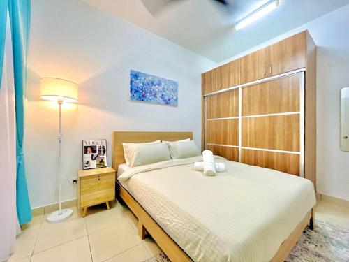 a bedroom with a large bed with a teddy bear on it at Alanis Suite with NETFLIX @ KLIA Sepang in Sepang