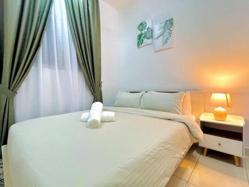 a bedroom with a white bed and a window at Alanis Suite with NETFLIX @ KLIA Sepang in Sepang