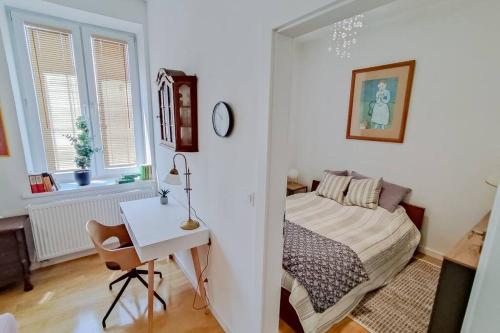 a bedroom with a bed and a table and a desk at Apartment Laizor in Staszów