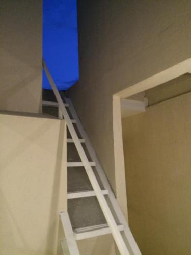 a ladder leading up to a bunk bed at Stone House Hotel Pasay in Manila