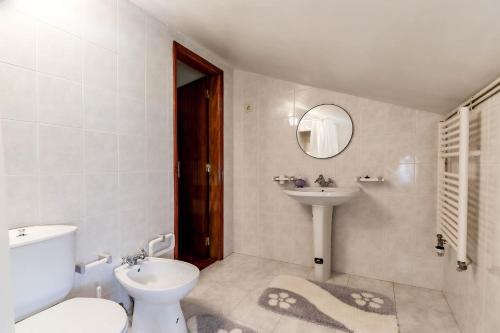 a bathroom with a toilet and a sink at Casa do Azal in Ponte de Lima