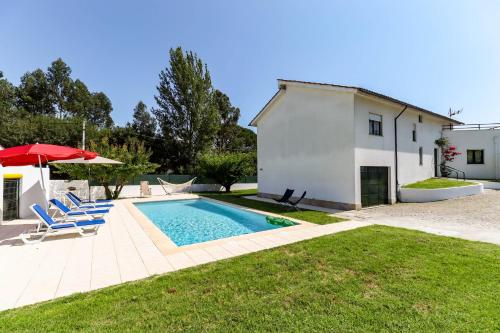 a villa with a swimming pool and a house at Casa do Azal in Ponte de Lima