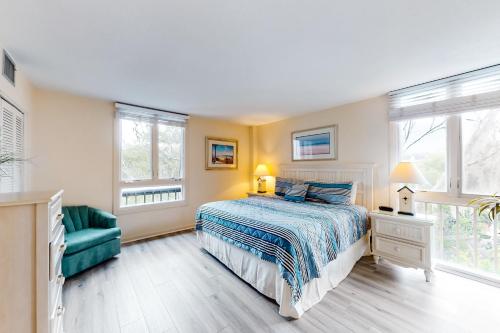 a bedroom with a bed and a green couch at Ketch Court 893 in Hilton Head Island
