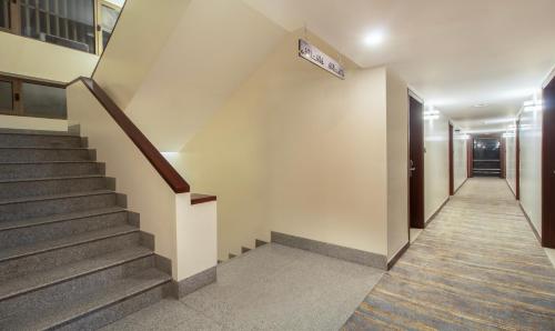 a hallway with stairs and a sign on the wall at Treebo Regency - Bund Garden, Dhole Patil Road in Pune