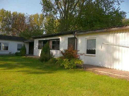 a white house with a yard in front of it at Ruegen_Fewo 102 in Sagard