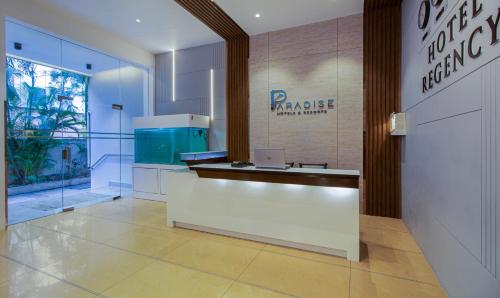 a lobby of a pharmacy with a laptop on a counter at Treebo Regency - Bund Garden, Dhole Patil Road in Pune