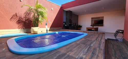 a large jacuzzi tub in the middle of a room at Casa Nova temporada piscina aquecida 24hs in Olímpia