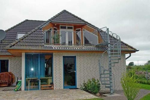 a house with a balcony on top of it at Ruegen_Fewo 137 in Zudar