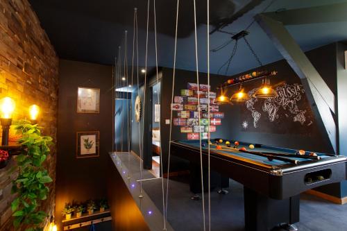 a billiard room with a pool table in a room at Sweety Loft Suites romantique avec jacuzzi in Friville-Escarbotin