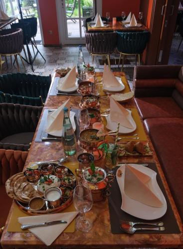 a long table with plates of food on it at Park Hotel Berlin in Bad Fallingbostel