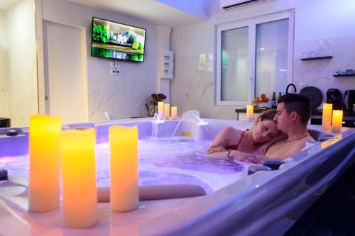 a man and a woman in a hot tub at Sweety Loft Suites romantique avec jacuzzi in Friville-Escarbotin