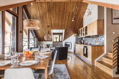 a kitchen and dining room with a table and chairs at Åre's best family home in Åre