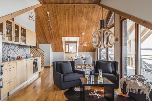 a kitchen and living room with a table and chairs at Åre's best family home in Åre