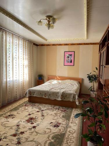 a bedroom with a bed and a rug at family homestay in Osh